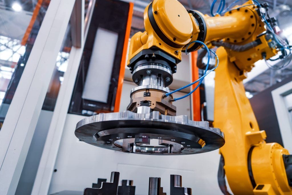 Industrial robot arm in a CNC machining cell