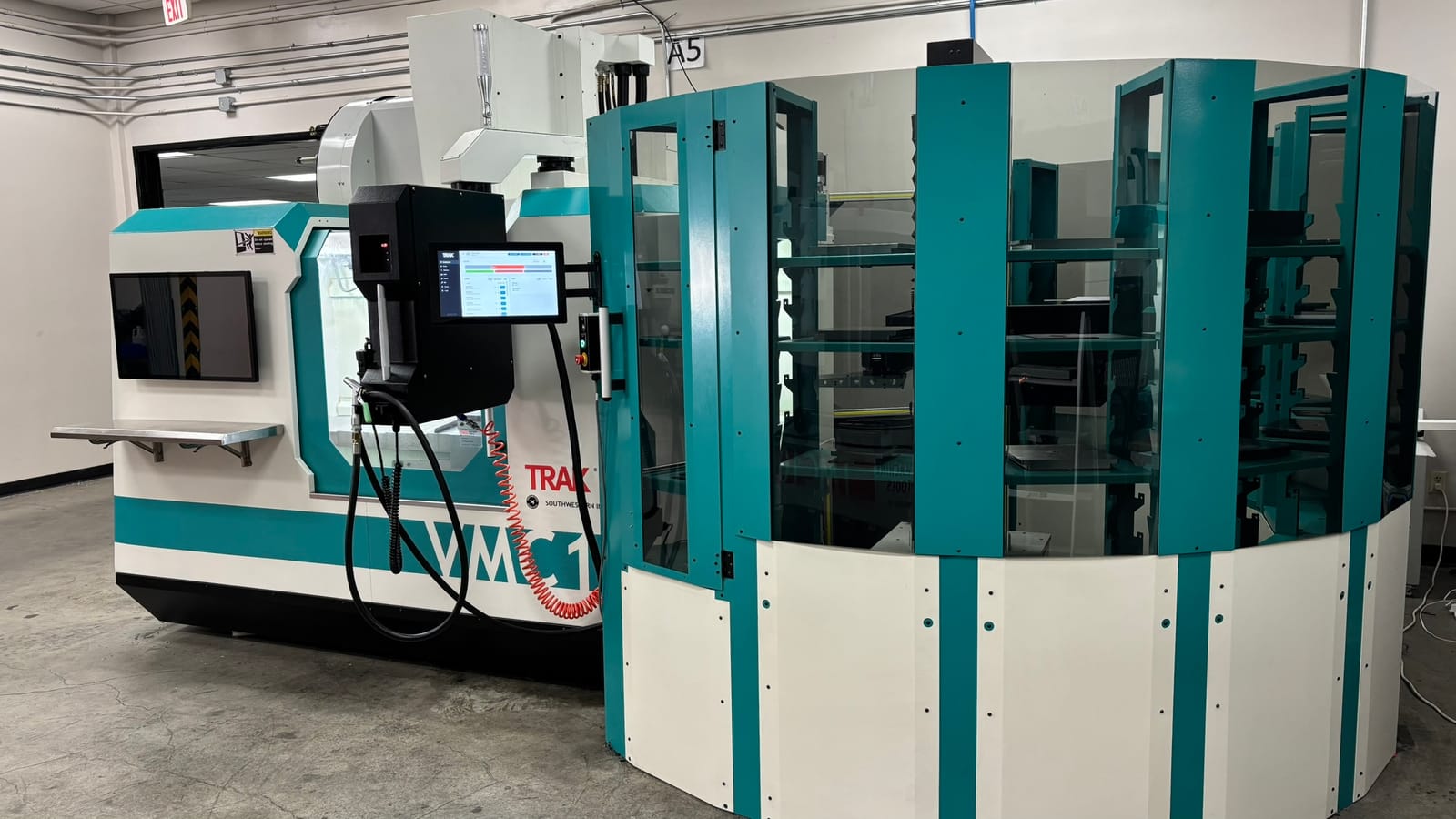 Night Shift machine-tending system next to a CNC machine
